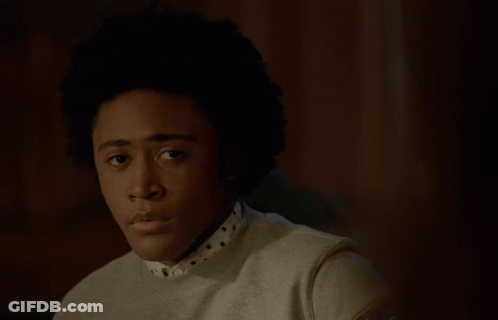 Young Man With Afro In Sweater And Polka Dot Shirt GIF