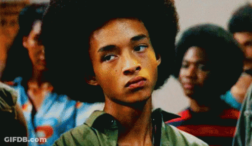 Young Man With Afro Making Funny Face In Crowd GIF
