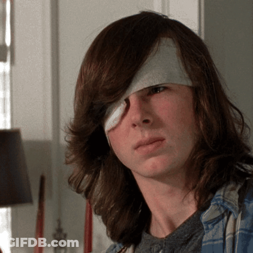 Young Man With Bandage On Eye Looking At Camera GIF