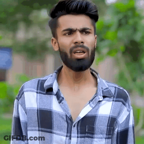 Young Man With Beard In Plaid Shirt GIF