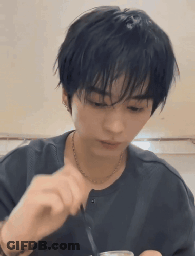 Young Man With Black Hair And Necklace Eating With Spoon GIF