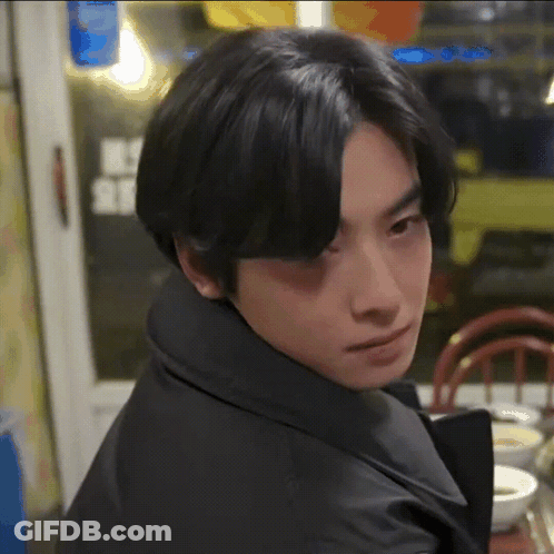 Young Man With Black Hair Sitting At Table With Bowl Of Soup GIF
