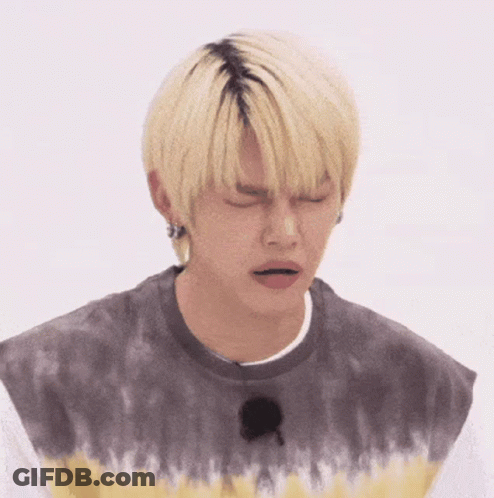Young Man With Blonde Hair In Tie Dye Shirt Sad Face GIF