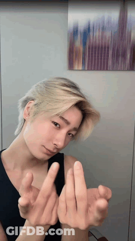 Young Man With Blonde Hair Making Heart GIF