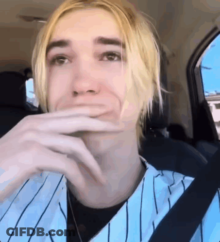 Young Man With Blonde Hair Sitting In Back Seat Hand On Mouth GIF