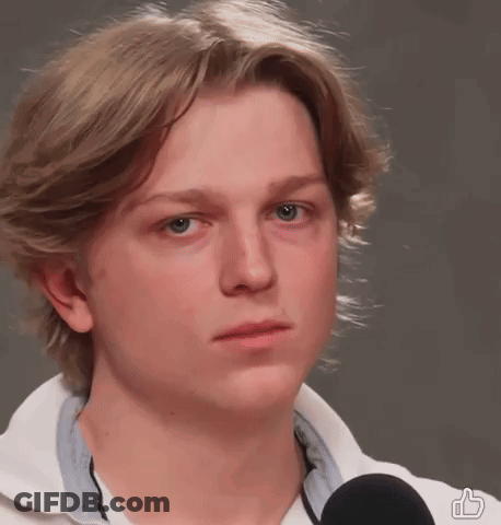 Young Man With Blonde Hair Wearing White Shirt And Black Microphone GIF