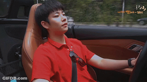 Young Man With Blue Backpack Walking Down Hallway GIF