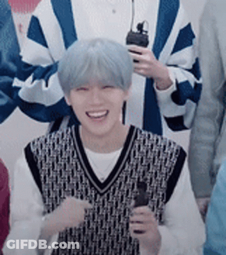Young Man With Blue Hair Holding Microphone Smiling GIF