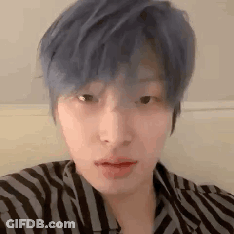 Young Man With Blue Hair In Striped Shirt GIF