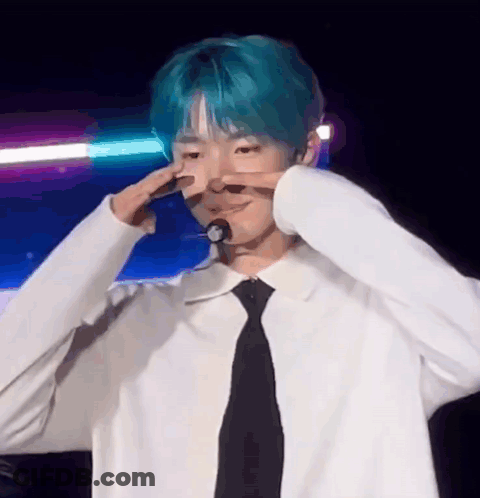 Young Man With Blue Hair Making Peace Sign GIF