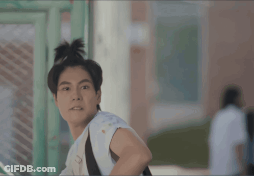 Young Man With Bun And Backpack GIF