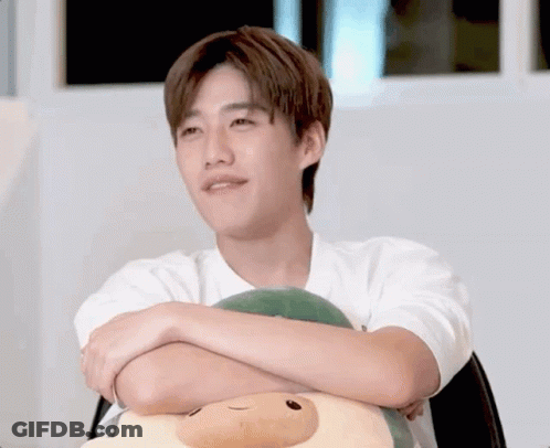 Young Man With Crossed Arms Holding Stuffed Animal GIF