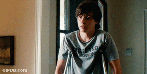 Young Man With Crutches In Rock And Roll School Shirt GIF