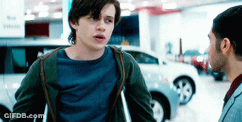 Young Man With Crutches Talking To Another Man GIF