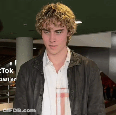 Young Man With Curly Blonde Hair And Leather Jacket GIF
