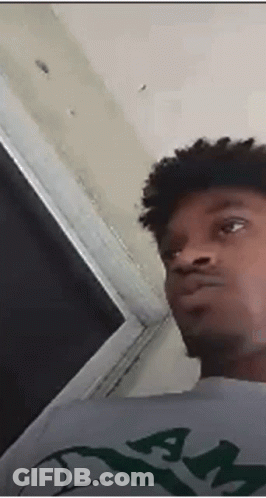 Young Man With Curly Hair And Gray Shirt With Letter A GIF