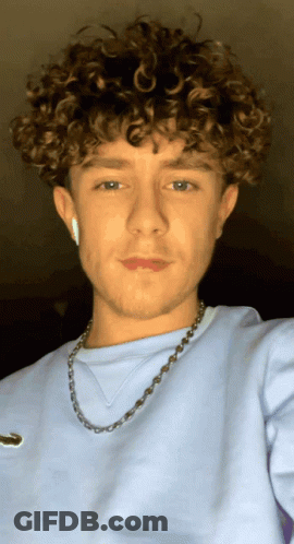 Young Man With Curly Hair And Necklace GIF