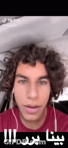 Young Man With Curly Hair Headphones Red Shirt Arabic Writing On Face GIF