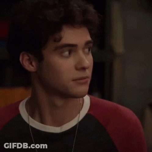 Young Man With Curly Hair In Black And Red Sweater GIF