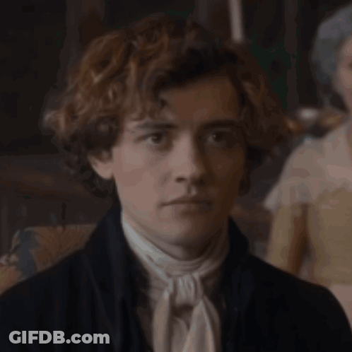Young Man With Curly Hair In Black Jacket And White Tie GIF