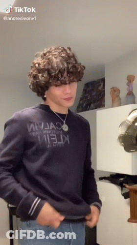 Young Man With Curly Hair In Blue Sweater Saying Ninja GIF