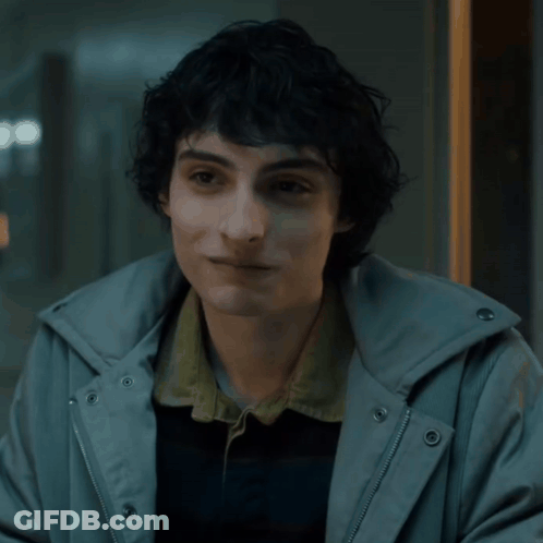 Young Man With Curly Hair In Grey Hoodie GIF
