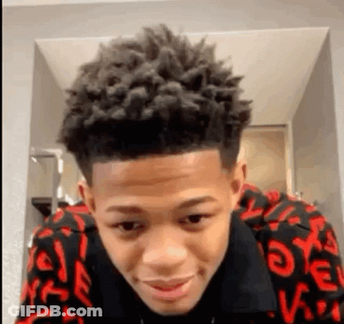 Young Man With Curly Hair In Red And Black Sweater GIF