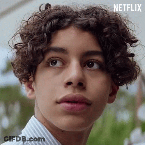 Young Man With Curly Hair In Striped Shirt GIF