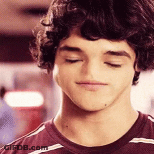 Young Man With Curly Hair In Striped Shirt GIF
