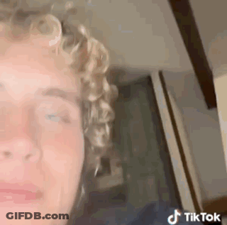Young Man With Curly Hair Looking At Camera GIF