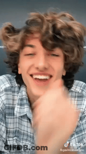 Young Man With Curly Hair Making Funny Face GIF