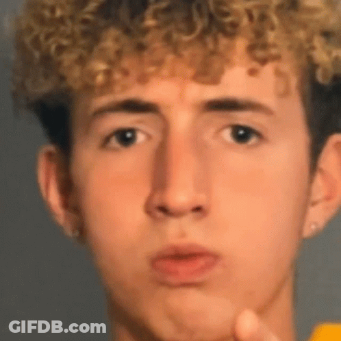 Young Man With Curly Hair Making Funny Face GIF