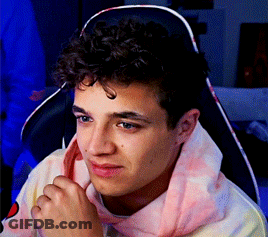 Young Man With Curly Hair Sitting GIF