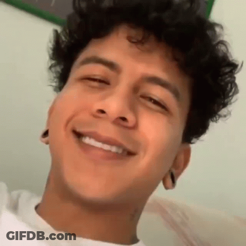 Young Man With Curly Hair Smiling Eyes Closed Mouth Open GIF
