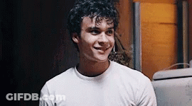 Young Man With Curly Hair Smiling In White T-Shirt GIF