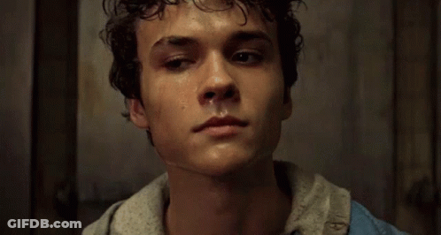 Young Man With Curly Hair Smiling In White T-Shirt GIF