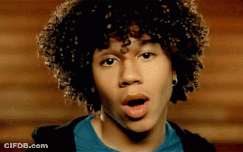 Young Man With Curly Hair Surprised Mouth Open GIF