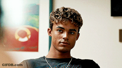 Young Man With Curly Hair Wearing Headphones And Black Shirt GIF
