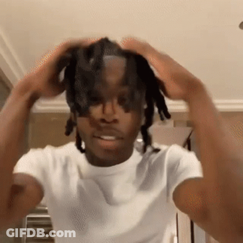 Young Man With Dreadlocks Holding Head In Hands GIF