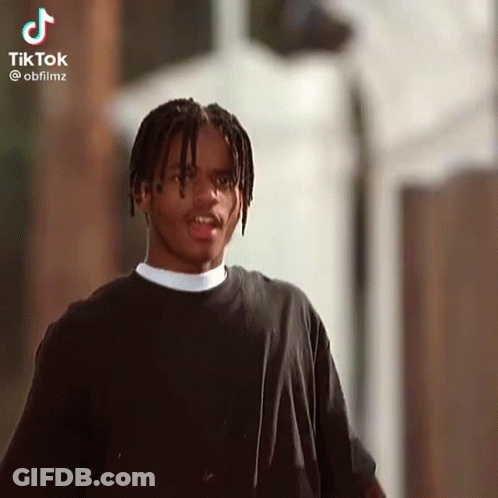 Young Man With Dreadlocks Looking At Camera GIF