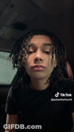 Young Man With Dreadlocks Making Funny Face In Car GIF