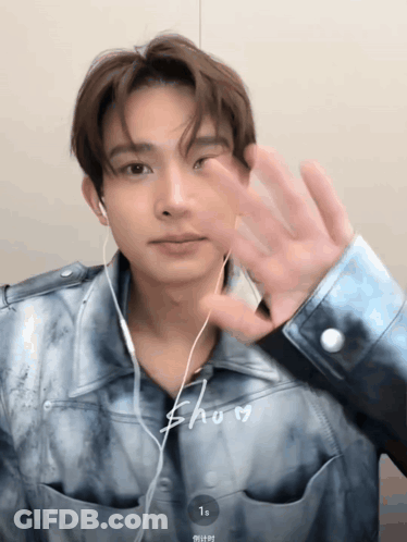 Young Man With Ear Buds And Blue Shirt Saying Show GIF