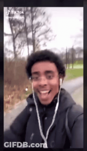 Young Man With Ear Buds Smiling GIF