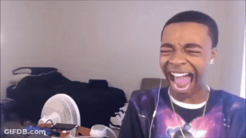 Young Man With Earbuds Laughing GIF