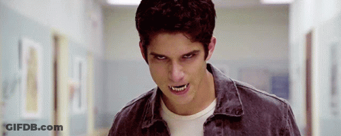 Young Man With Fangs Standing In Hallway Eyes Closed GIF