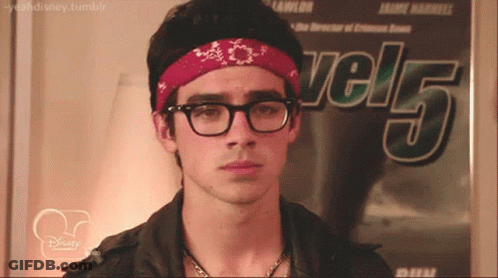 Young Man With Glasses And Bandana In Front Of Level 5 Poster GIF