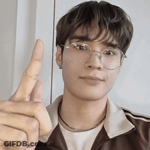 Young Man With Glasses And Brown Jacket Giving Thumbs Up GIF