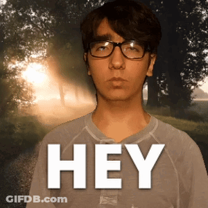 Young Man With Glasses And Grey Shirt Saying Hey GIF