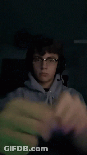 Young Man With Glasses And Headphones Holding Fist GIF
