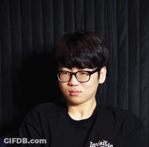 Young Man With Glasses Smiling Before Black Curtain GIF